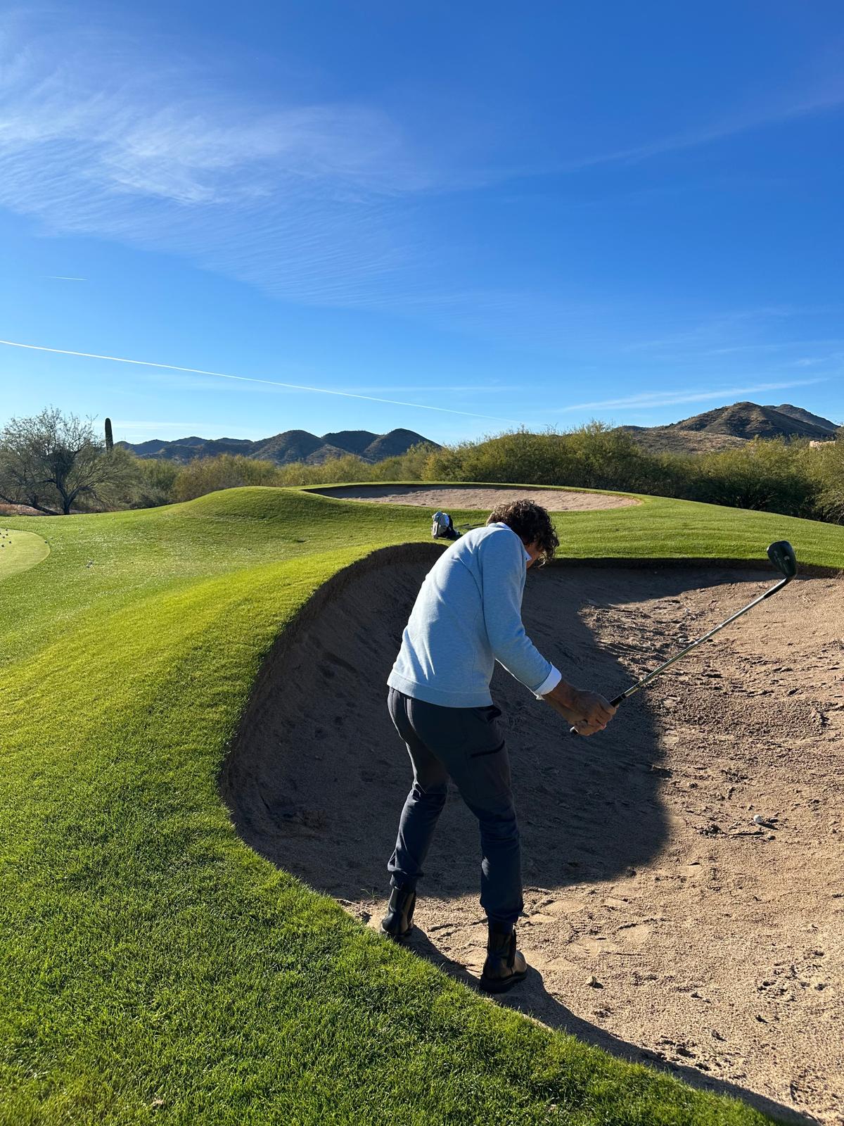 Golf player practicing a bunker shot