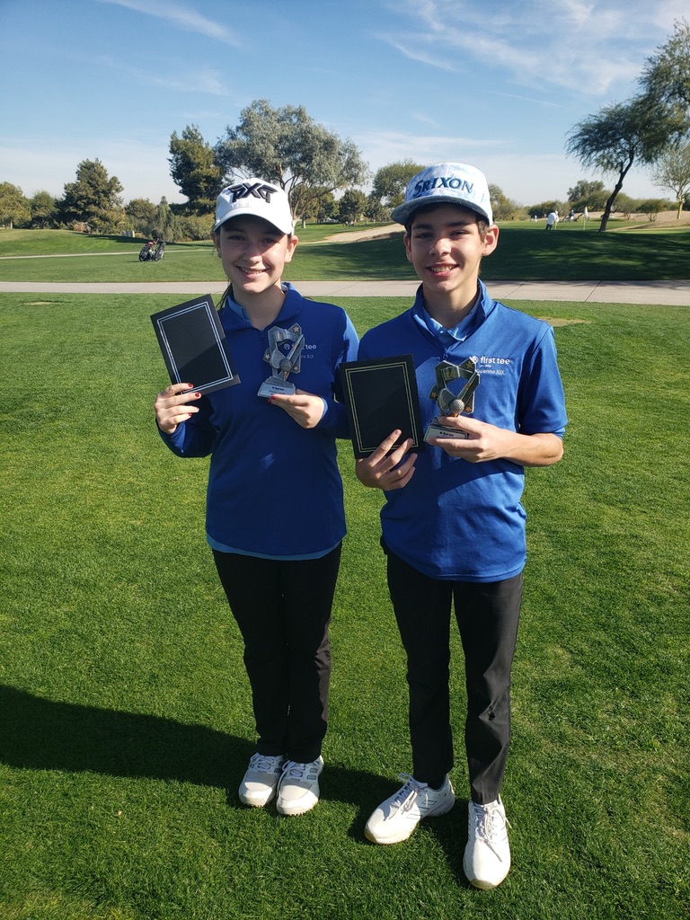 Junior golfers holding trophies