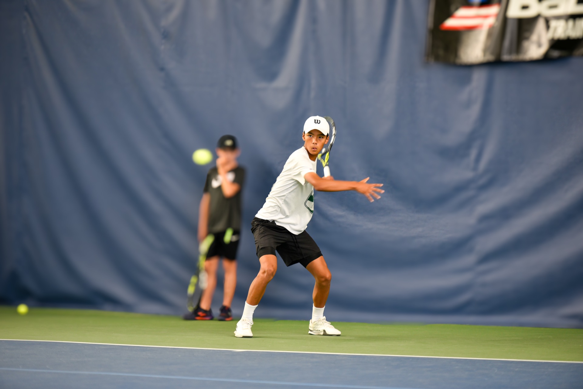 Competitive tennis action at Tier 1