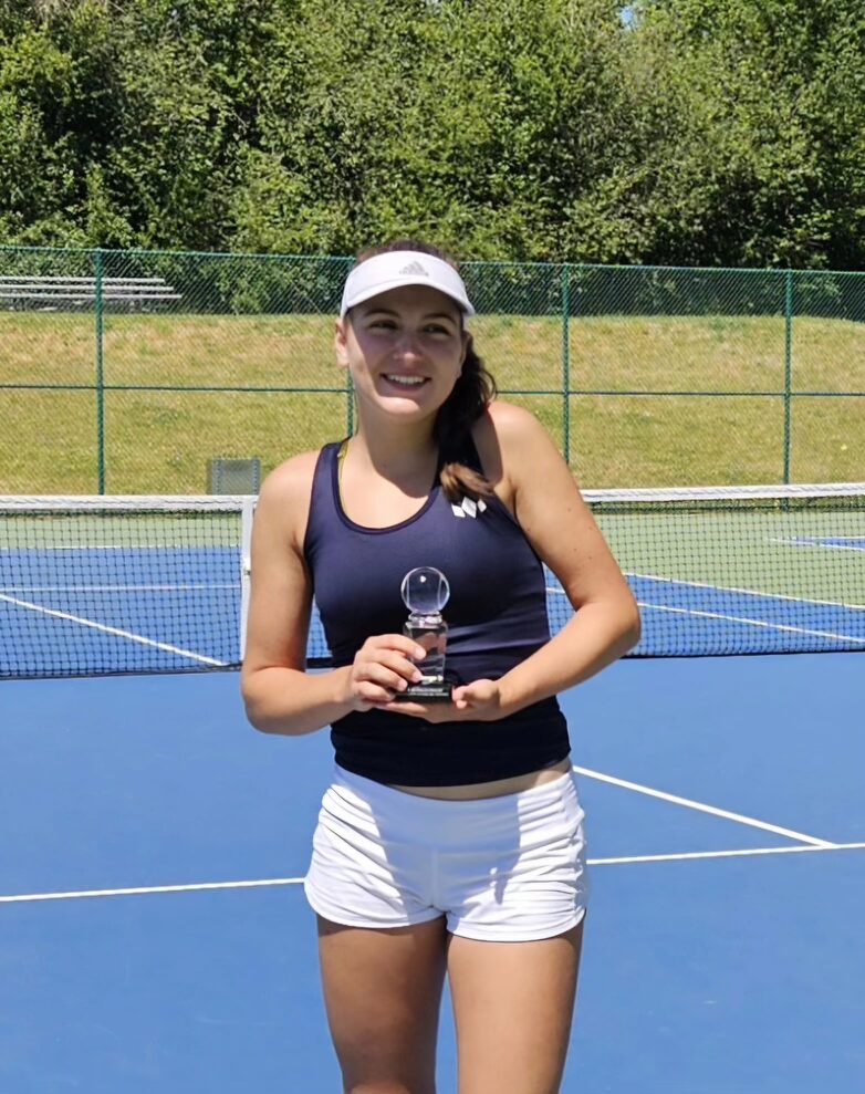 Tier 1 tennis athlete holding a trophy on court
