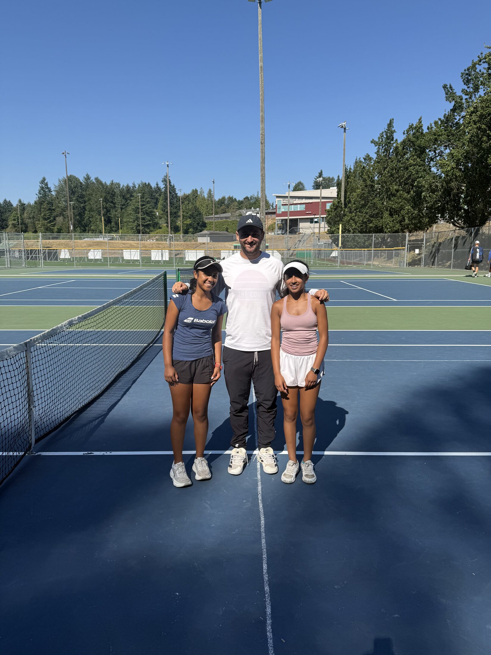 Tier 1 junior tennis athletes standing at the net