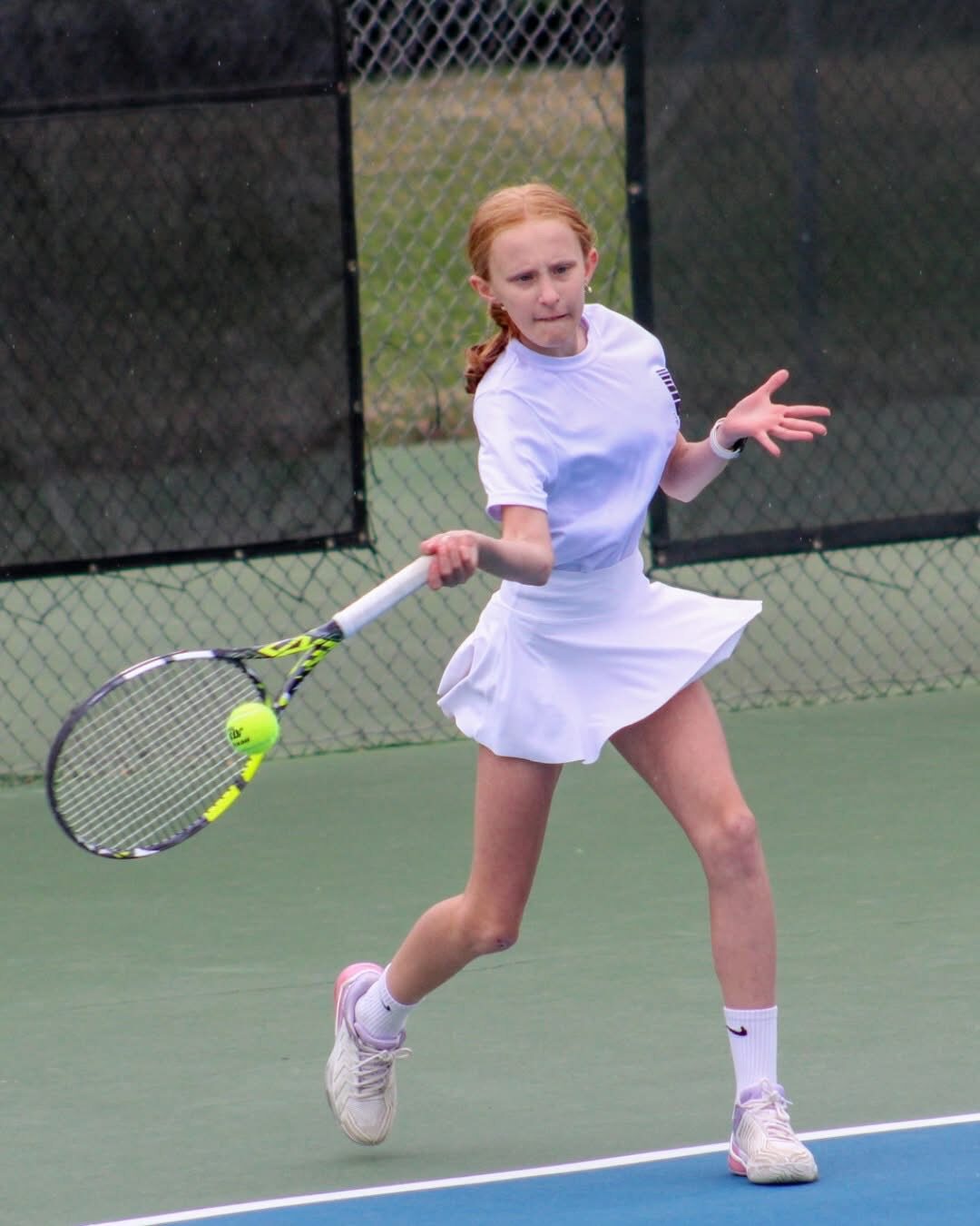 Tier 1 junior tennis player hitting a forehand