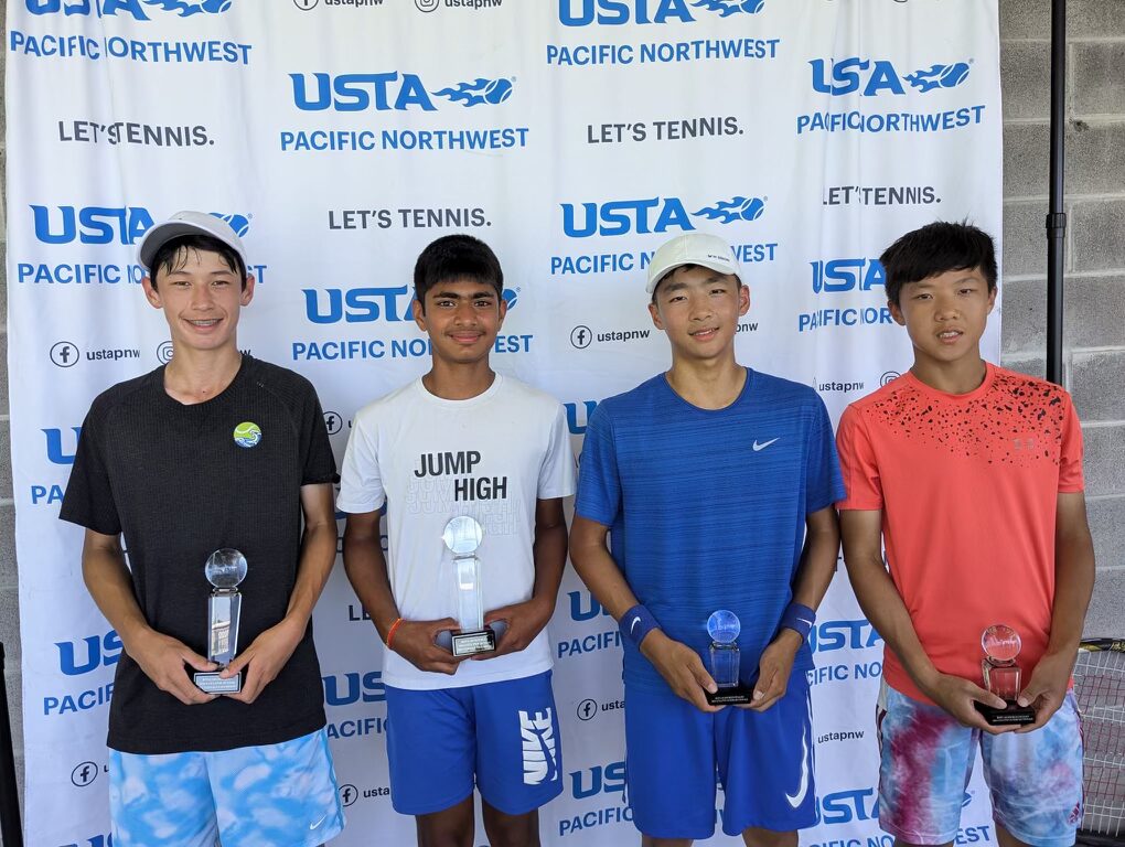 Tier 1 boys tennis finalists holding trophies at a USTA event